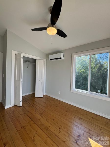 Bedroom on upper level, natural light, ceiling fan, warm finishes Bedroom on upper level, natural light, ceiling fan, warm finishes