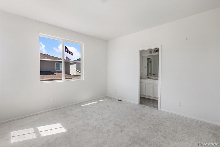 Upper level primary bedroom with adjoining bathroom
