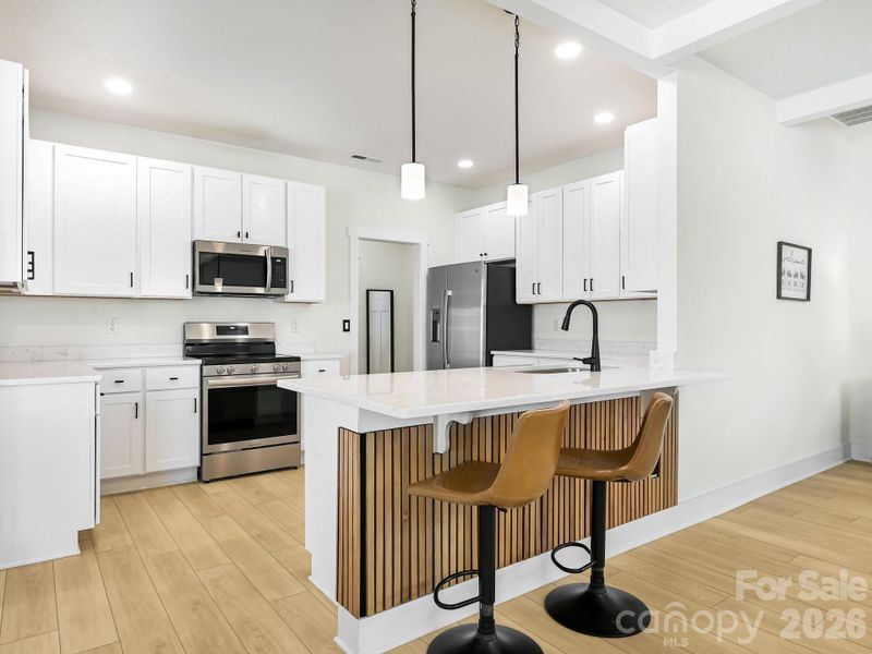 Breakfast bar. Custom wall panels, may convey with home.