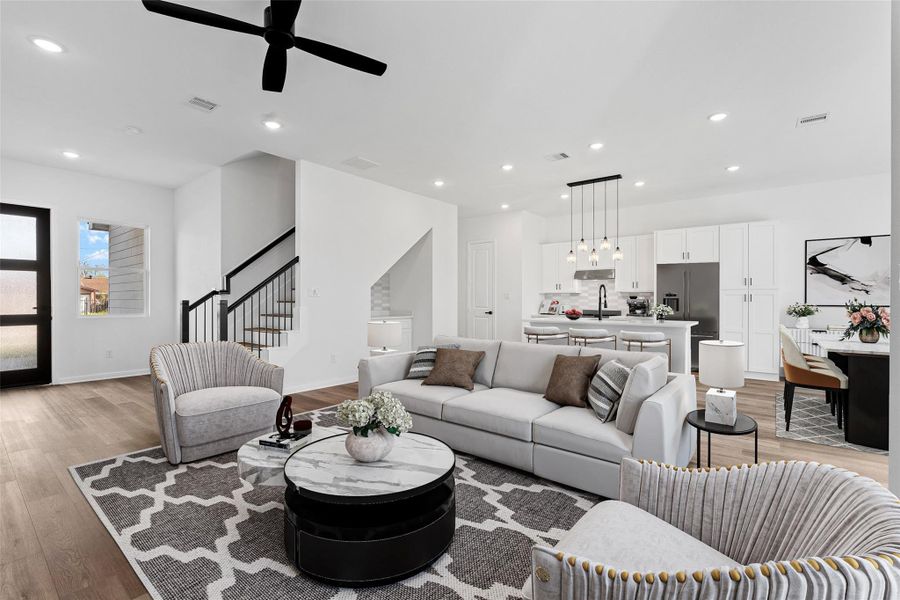 Comfortable staged living space with a sectional sofa and area rug, highlighting the home’s bright and airy feel.