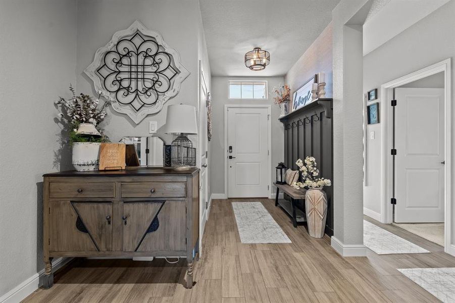 Foyer with light hardwood / wood-style flooring