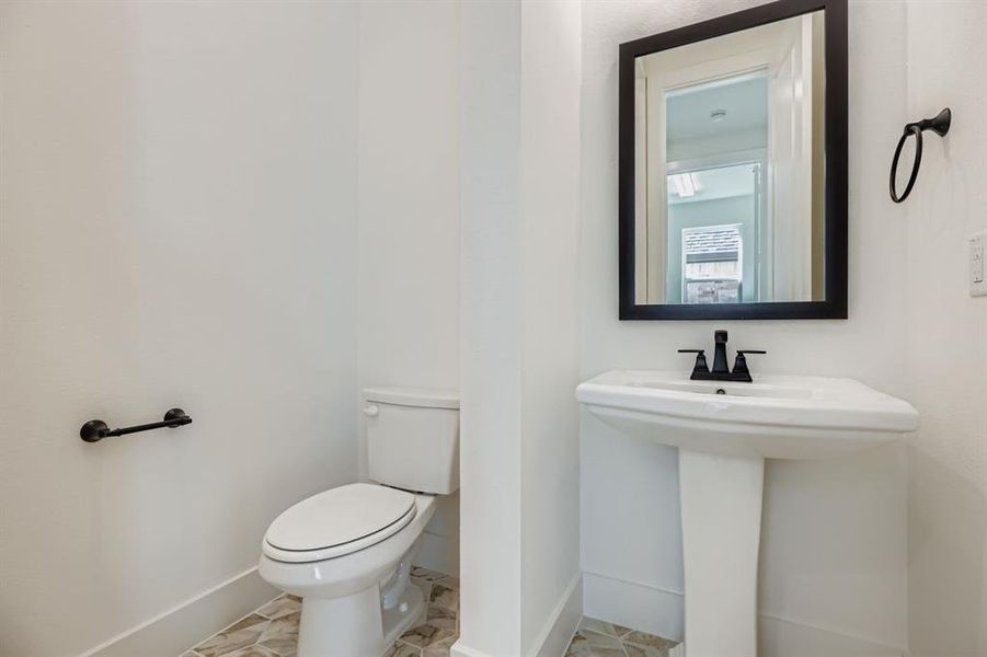 Half bath with baseboards and toilet Half bath with baseboards and toilet