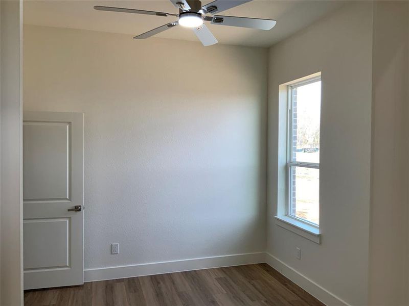 Empty room featuring wood finished floors and ceiling fan Empty room featuring wood finished floors and ceiling fan