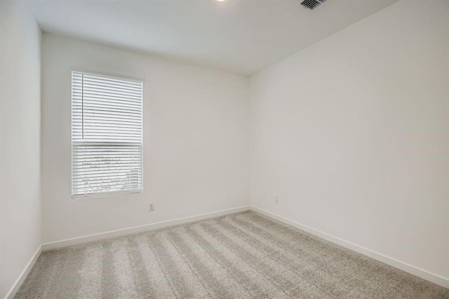 Carpeted empty room with baseboards