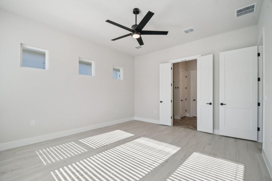 Unfurnished bedroom featuring light wood-style floors and ceiling fan