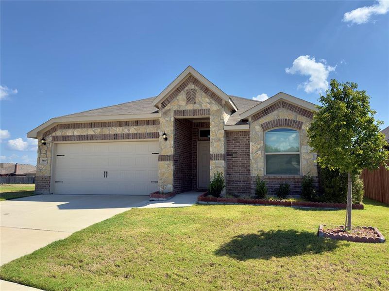 Ranch-style house with brick siding, driveway, an attached garage, and stone siding Ranch-style house with brick siding, driveway, an attached garage, and stone siding