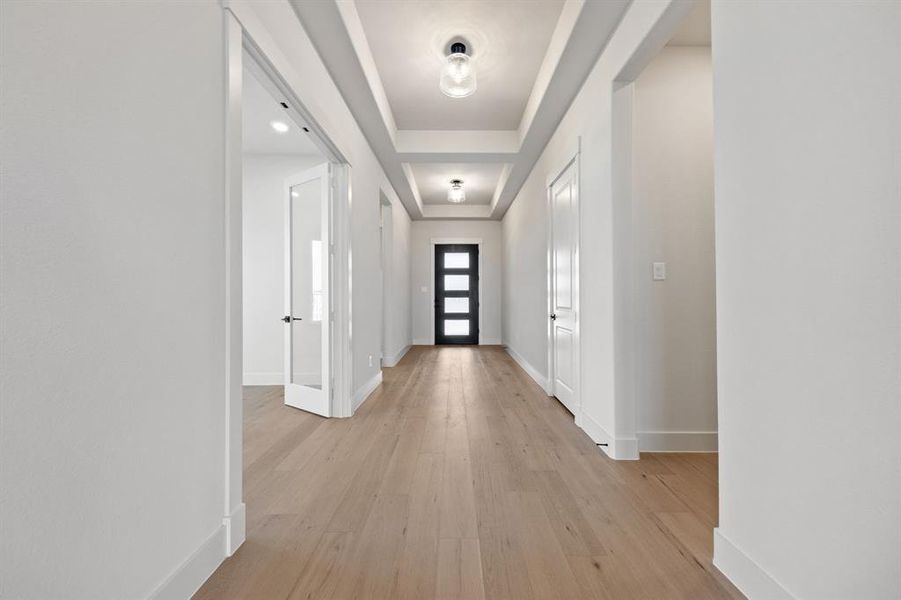 This stunning entry featuring glass & wood entry door, beautiful flooring and ample wall space for art work is the perfect place for you to welcome family and friends into your new dream home!