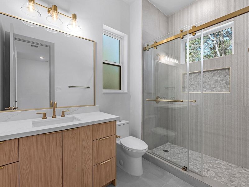 Beautifully finished bathrooms combine clean design with quality materials, creating cohesive and elevated spaces throughout the home.