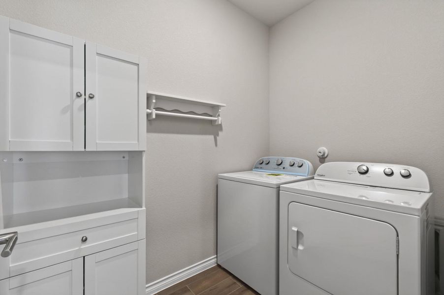 Functional laundry room equipped with contemporary appliances and practical cabinetry for seamless home management. Functional laundry room equipped with contemporary appliances and practical cabinetry for seamless home management.