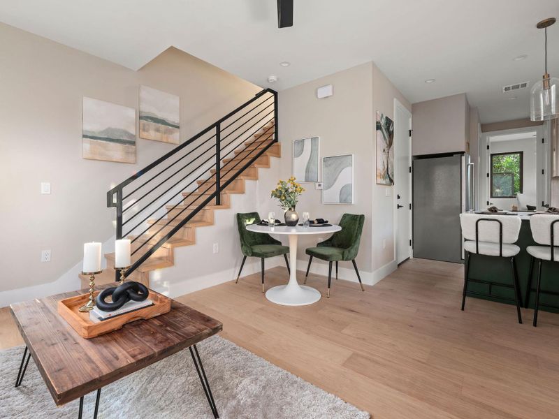 Living room featuring light wood finished floors and stairway