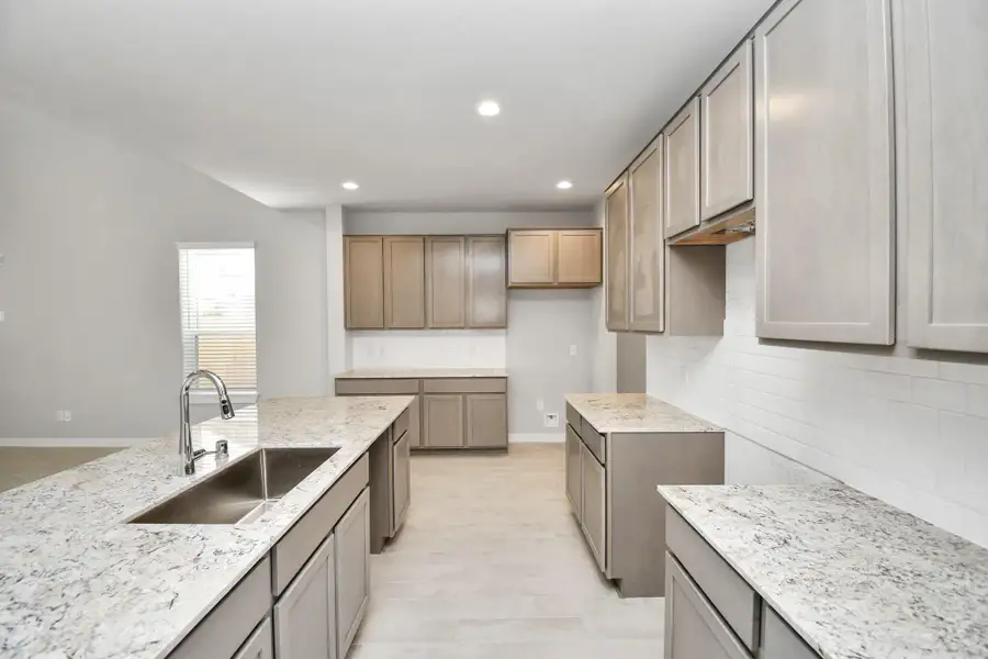 This generously spacious kitchen is a dream realized! Sample photo of completed home with similar floor plan. Actual colors and selections may vary.