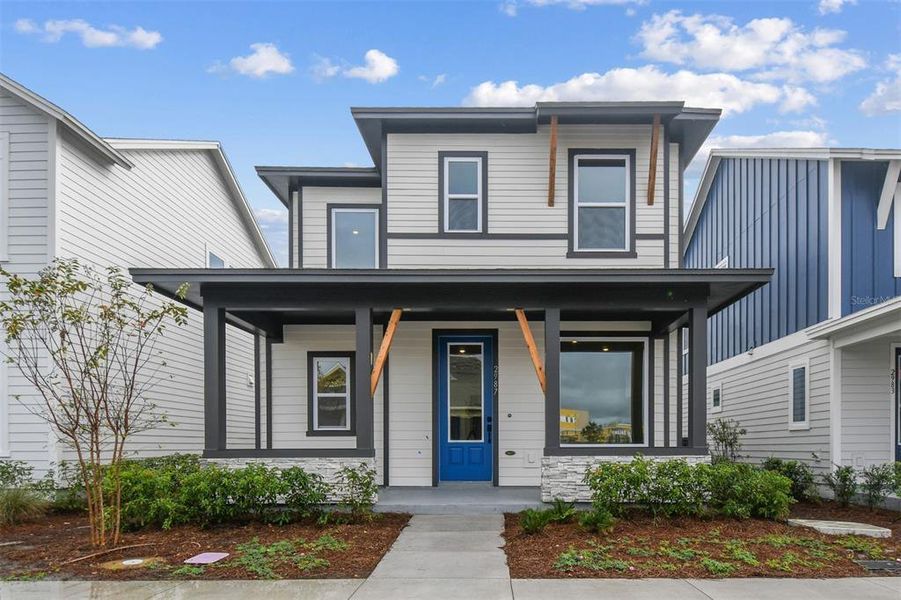 Front exterior of a new home in Weslyn Park in Sunbridge 34', St. Cloud, FL, highlighting curb appeal (Image 1).