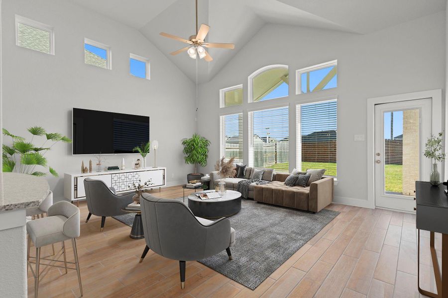 The spacious family room is filled with natural light from a wall of windows and tall ceilings, creating an open, airy atmosphere that’s perfect for gatherings. This space captures the San Marcos Floor Plan’s seamless blend of elegance and comfort. *Photo Staged*