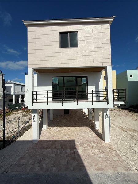 Front exterior of a new home in , Key Largo, FL, highlighting curb appeal (Image 1). Front exterior of a new home in , Key Largo, FL, highlighting curb appeal (Image 1).