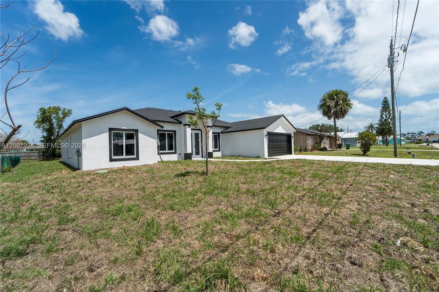 Front exterior of a new home in , Port St. Lucie, FL, highlighting curb appeal (Image 21).