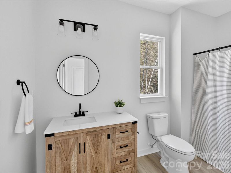 Stylish Jack-and-Jill bathroom showcases modern finishes, dual vanities, and a thoughtfully designed layout that seamlessly connects adjoining bedrooms for both convenience and privacy.