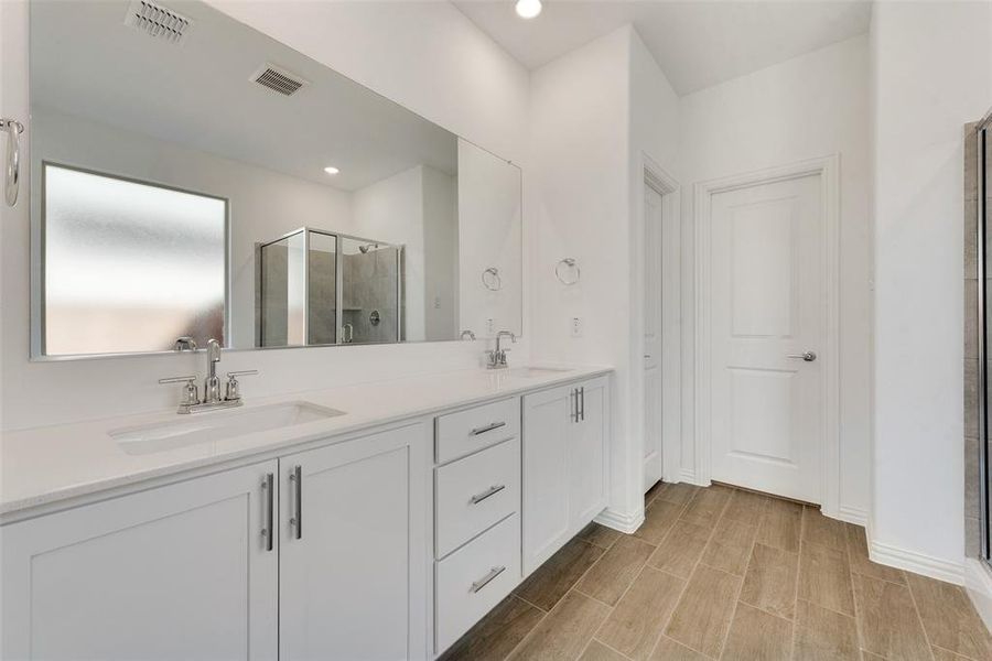 Bathroom with vanity and an enclosed shower