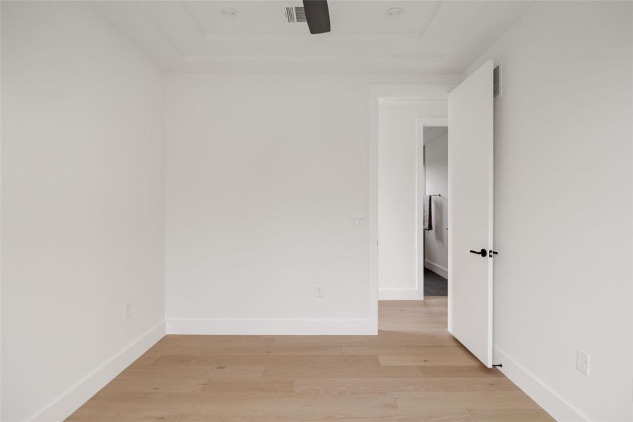 Spare room featuring light wood-type flooring and baseboards