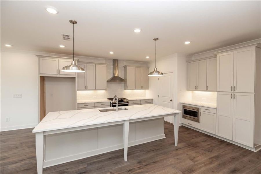 Look at this kitchen! Its very nice for cooking, hanging out, and you won't miss anytime with your family. Pictures represent a previously built home, not the actual home.