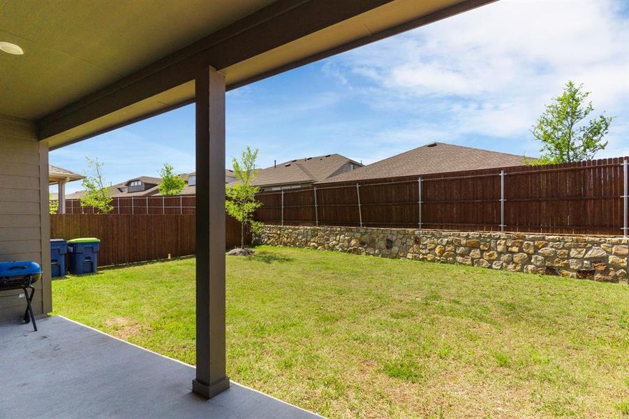 View of yard with a fenced backyard and a patio