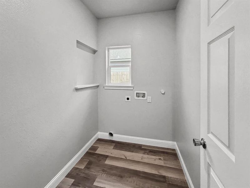 Laundry area with hookup for an electric dryer, washer hookup, baseboards, and dark wood finished floors Laundry area with hookup for an electric dryer, washer hookup, baseboards, and dark wood finished floors