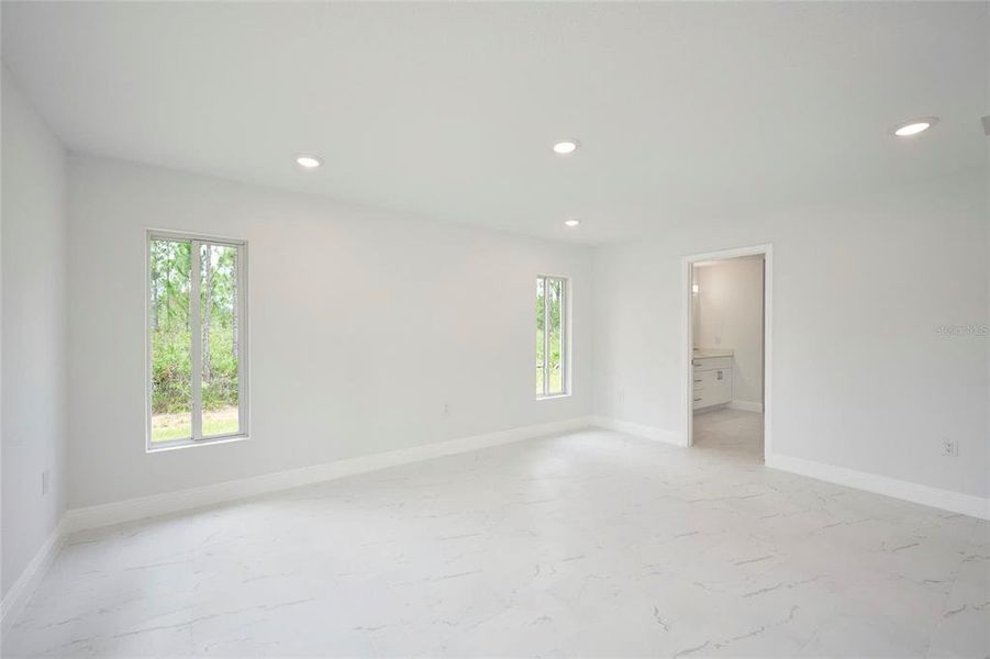 Master bedroom suite with view into master ensuite.