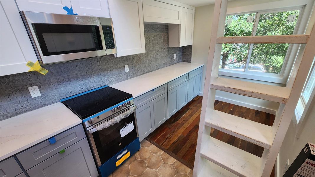 Kitchen looking into living room with space for TV. Kitchen looking into living room with space for TV.