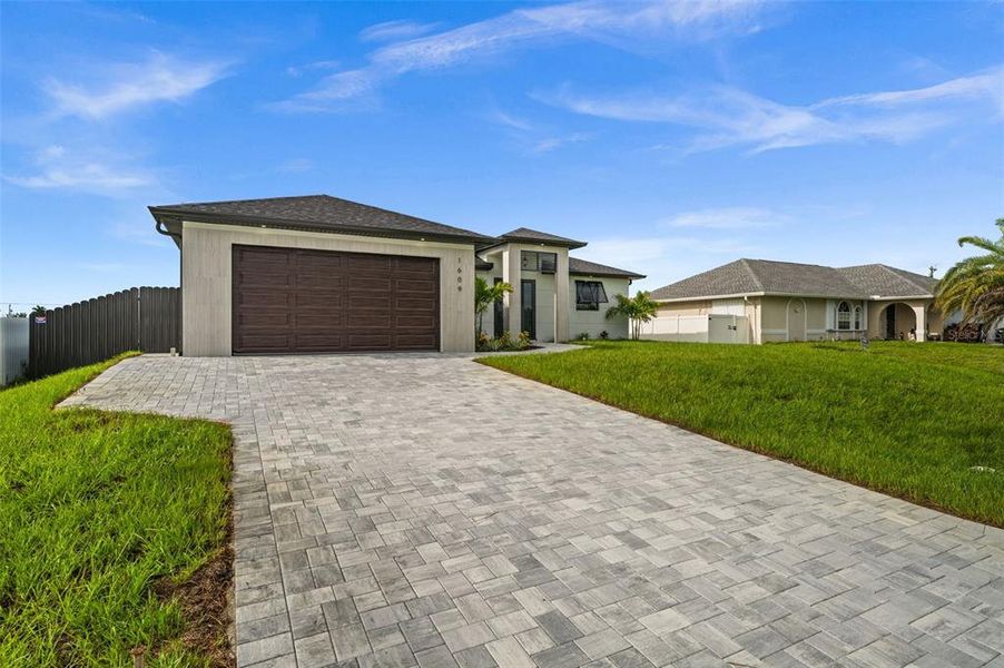 Front exterior of a new home in , Cape Coral, FL, highlighting curb appeal (Image 2). Front exterior of a new home in , Cape Coral, FL, highlighting curb appeal (Image 2).