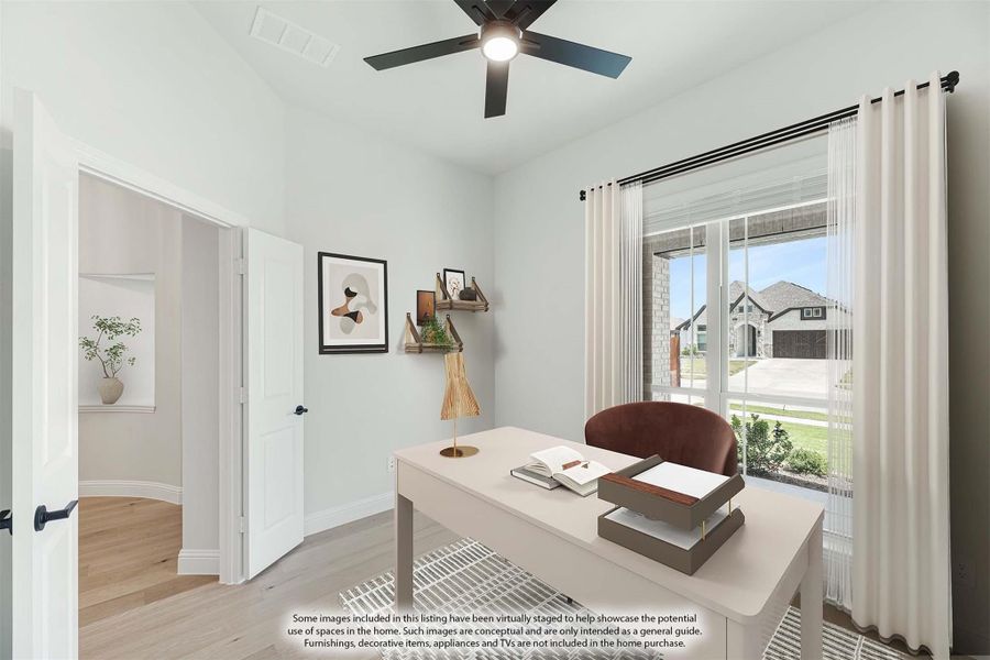 Home office with desk, ceiling fan, hardwood floors, and large window with neighborhood view