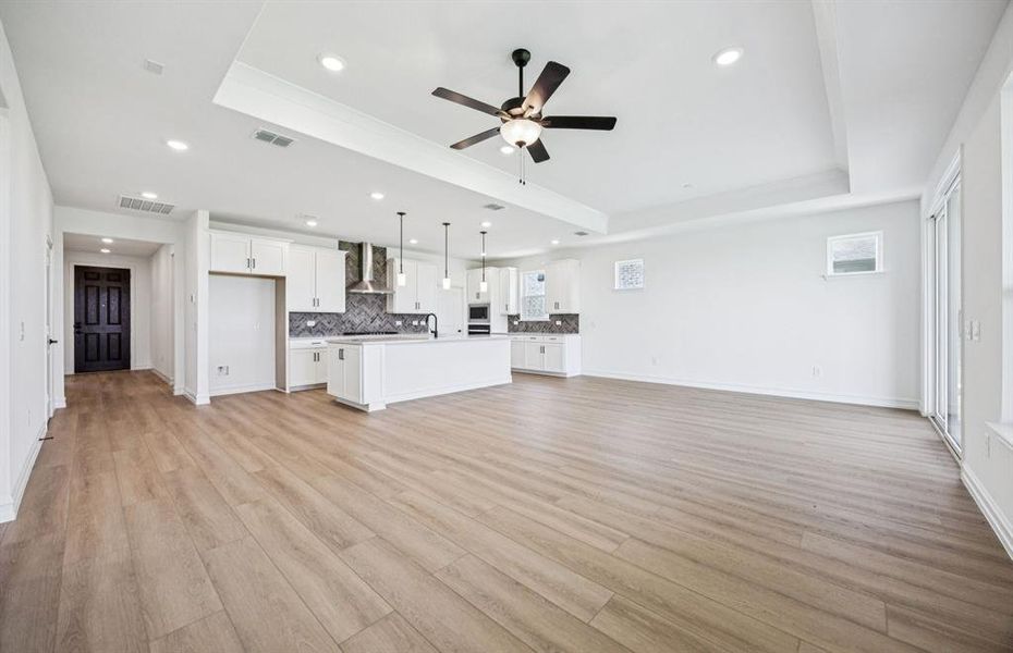 Open concept gathering room creating a spacious and inviting atmosphere *Real home pictured Open concept gathering room creating a spacious and inviting atmosphere *Real home pictured