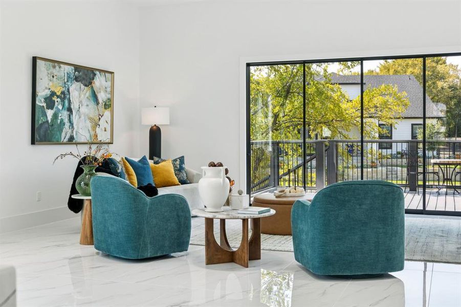 Living room featuring marble tiled flooring and baseboards Living room featuring marble tiled flooring and baseboards