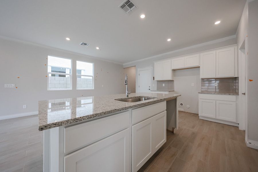A kitchen with white cabinets. A kitchen with white cabinets.