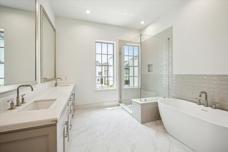 Opal White Polished Marble countertops with double sinks, soaking tub and glass walk-in shower.