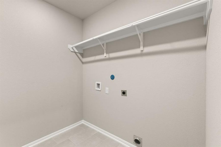 The laundry room layout is carefully planned for optimal workflow with designated areas for washing, drying, and storing.