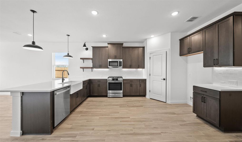 Lovely kitchen with dark stain cabinets and floating shelves (*Photo not of actual home and used for illustration purposes only.) Lovely kitchen with dark stain cabinets and floating shelves (*Photo not of actual home and used for illustration purposes only.)