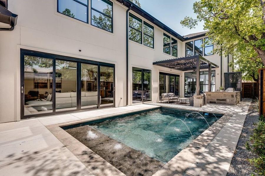 View of pool with pool water feature, a patio, and an outdoor hangout area