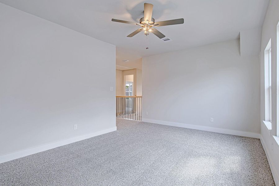 Another view of the  room shows its generous size and how it connects seamlessly to the rest of the second floor, making it the perfect hub for upstairs living.