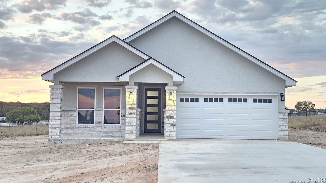 Front exterior of a new home in , La Vernia, TX, highlighting curb appeal (Image 2).