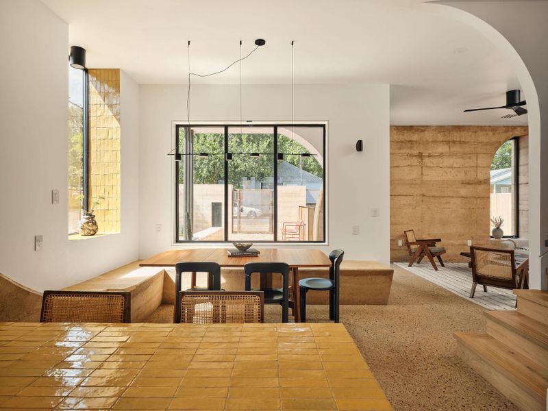 Featuring a rammed earth bench, polished concrete floors have been honed to reveal a terrazzo-like finish, adding texture and durability underfoot, and arched walkways Featuring a rammed earth bench, polished concrete floors have been honed to reveal a terrazzo-like finish, adding texture and durability underfoot, and arched walkways