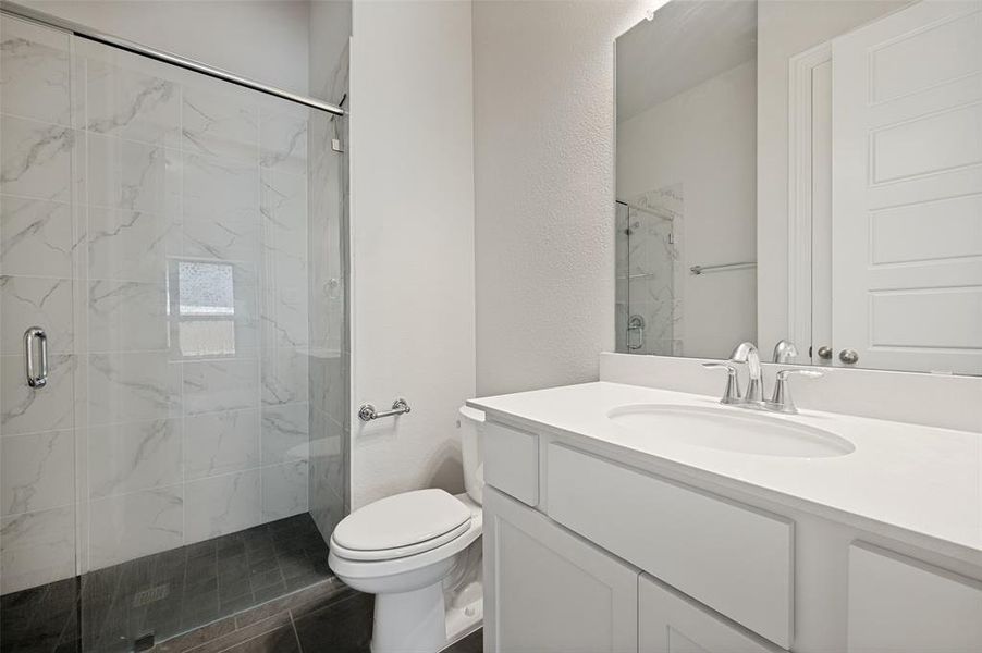 Private ensuite bath with quartz countertops, walk-in shower, and designer finishes. Private ensuite bath with quartz countertops, walk-in shower, and designer finishes.