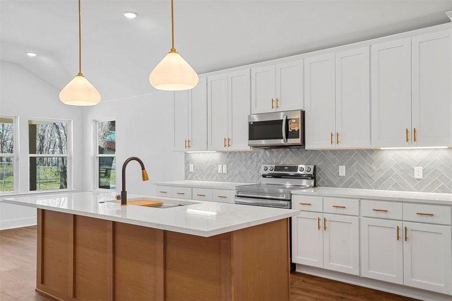 Kitchen featuring a sink, stainless steel appliances, dark wood-type flooring, and backsplash