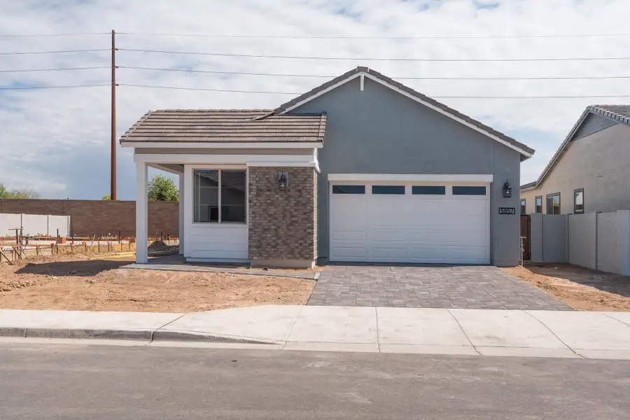 Front exterior of a new home in Waterston Central, Gilbert, AZ, highlighting curb appeal (Image 1). Front exterior of a new home in Waterston Central, Gilbert, AZ, highlighting curb appeal (Image 1).