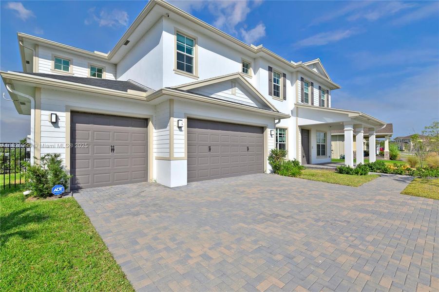 Front exterior of a new home in Arden: The Waterford Collection, Loxahatchee, FL, highlighting curb appeal (Image 25).