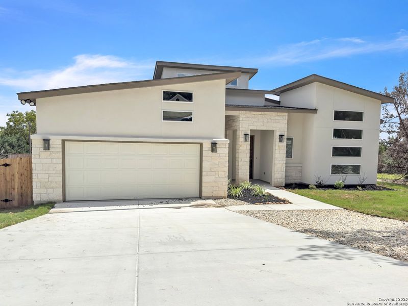Front exterior of a new home in , Blanco, TX, highlighting curb appeal (Image 17).