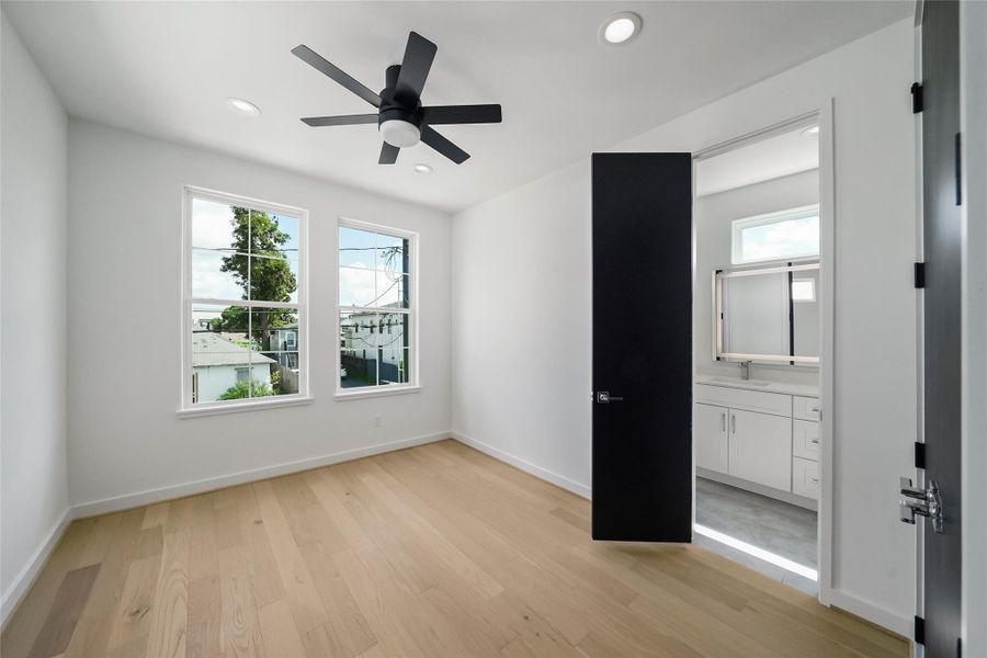Tranquil bedroom with dual windows bathing the space in natural light. Tranquil bedroom with dual windows bathing the space in natural light.
