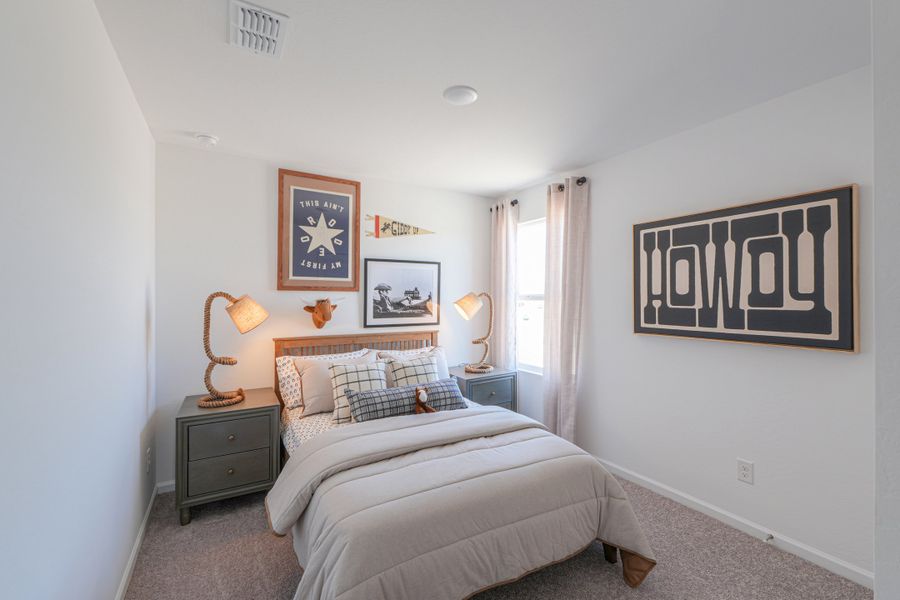 A bedroom with a bed and lamps.