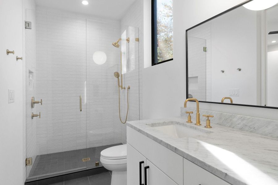 The private ensuite bathroom. All of the secondary/guest bathrooms provide modern vanities with granite countertops and luxurious modern finishes.