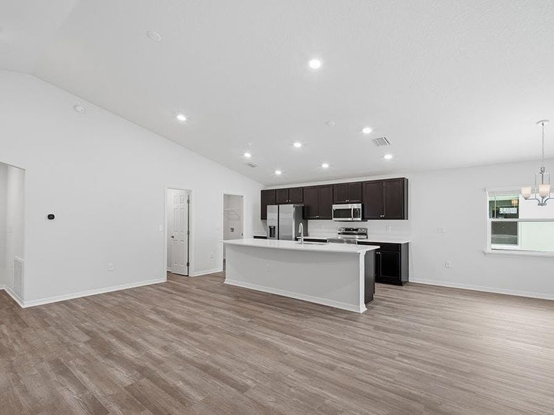 This home features a sunny, open concept living area with LVP flooring.