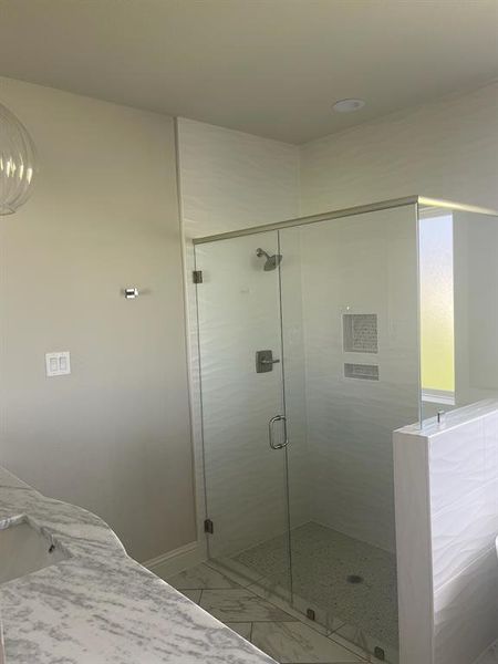 Full bath with marble finish flooring and a shower stall Full bath with marble finish flooring and a shower stall