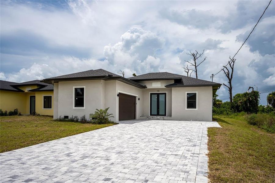 Front exterior of a new home in , Rotonda West, FL, highlighting curb appeal (Image 22).